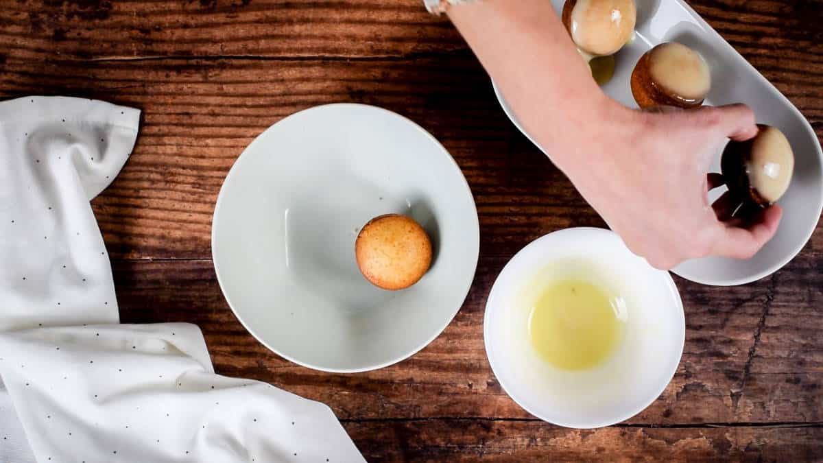 How to Make Cake Pops with a Cake Pop Maker Step 8-2 Baked cake pops and coating in bowls.