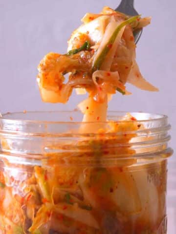 Kimchi in a jar and on a fork.