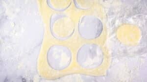 Dough circles on floured surface.