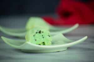 Mochi ice cream cut open on small plate close up.