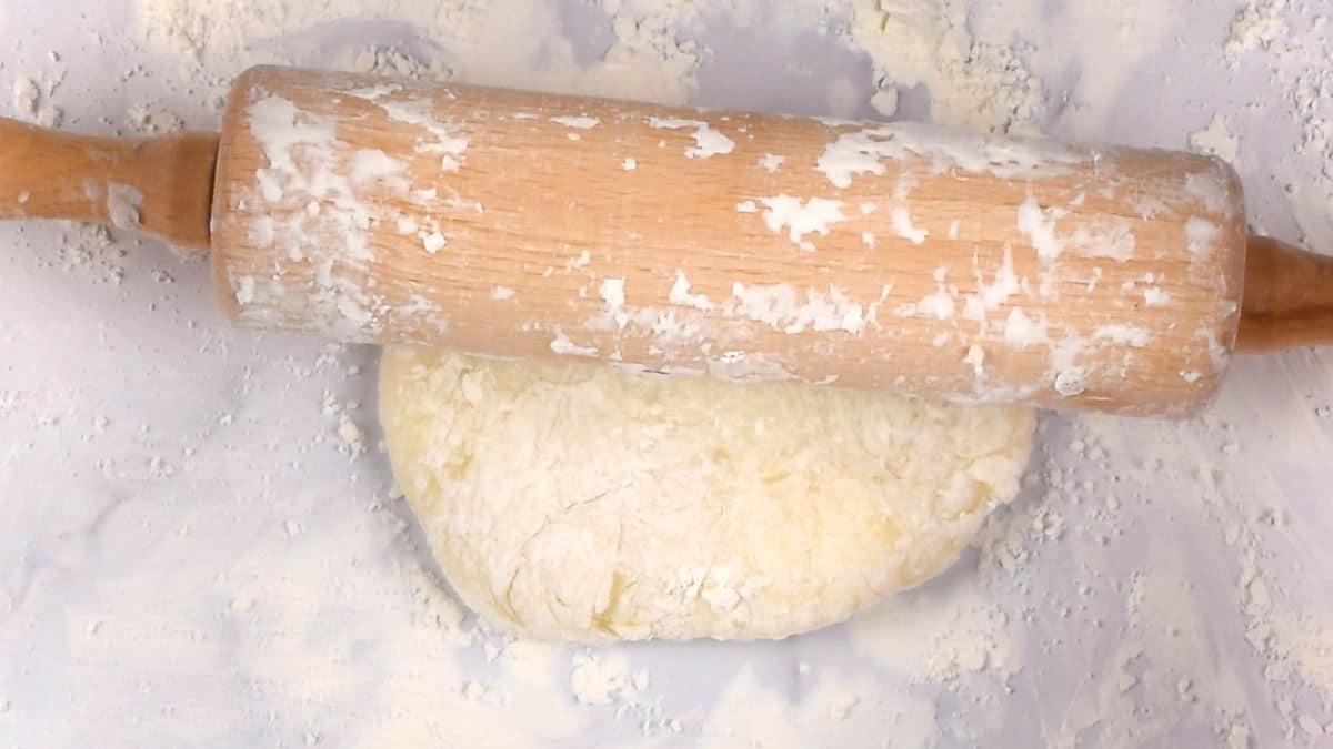 How to Make Mochi Ice Cream Step 5 Rolling pin on mochi dough ball on floured surface.