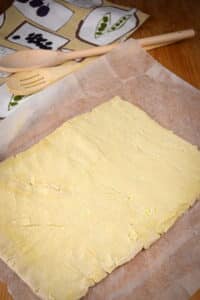Puff pastry sheet on parchment paper.