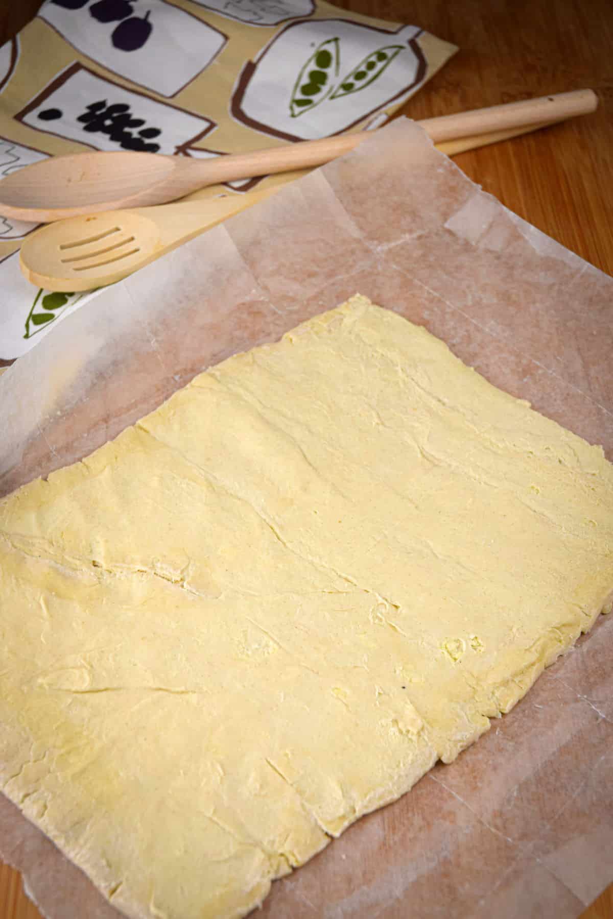 Puff pastry sheet on parchment paper.
