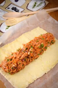 Puff pastry with sausage filling in the center.