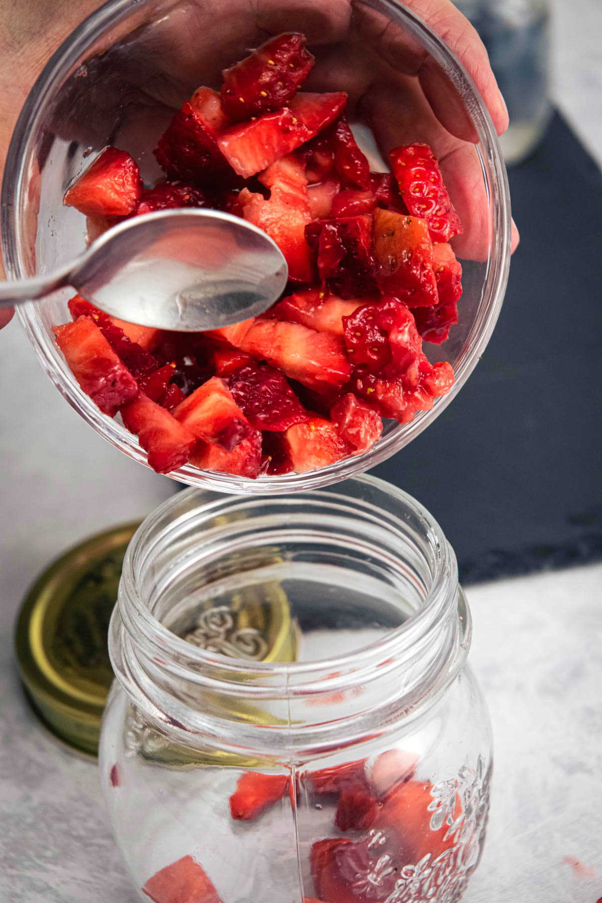 Freshly chopped strawberries in a jar.