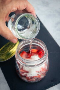 Vodka strawberry infusion in a jar.