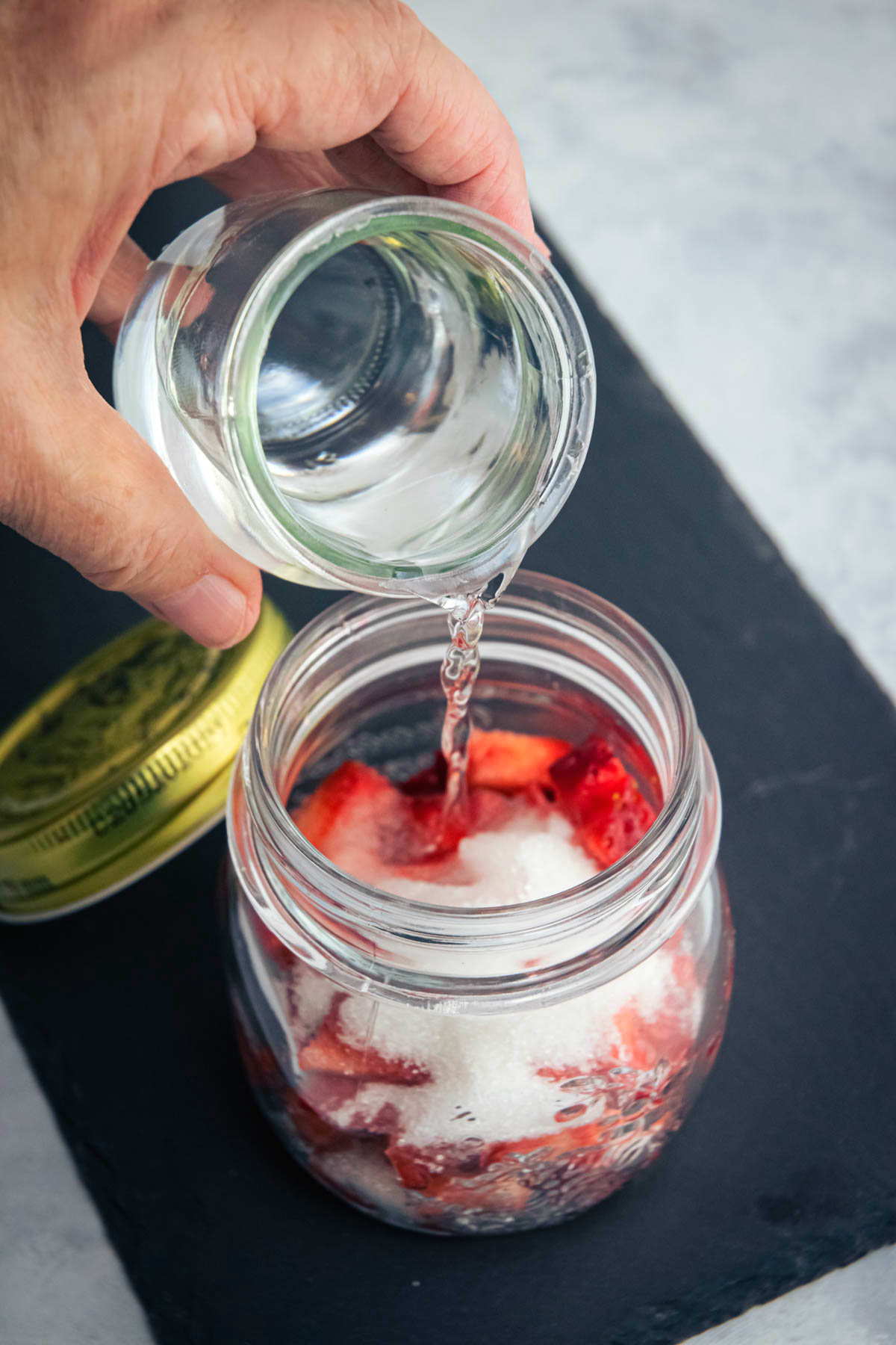 Vodka strawberry infusion in a jar.