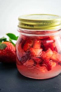 Vodka strawberry infusion in a jar.