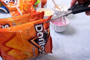 A small bag of Doritos with scissors.