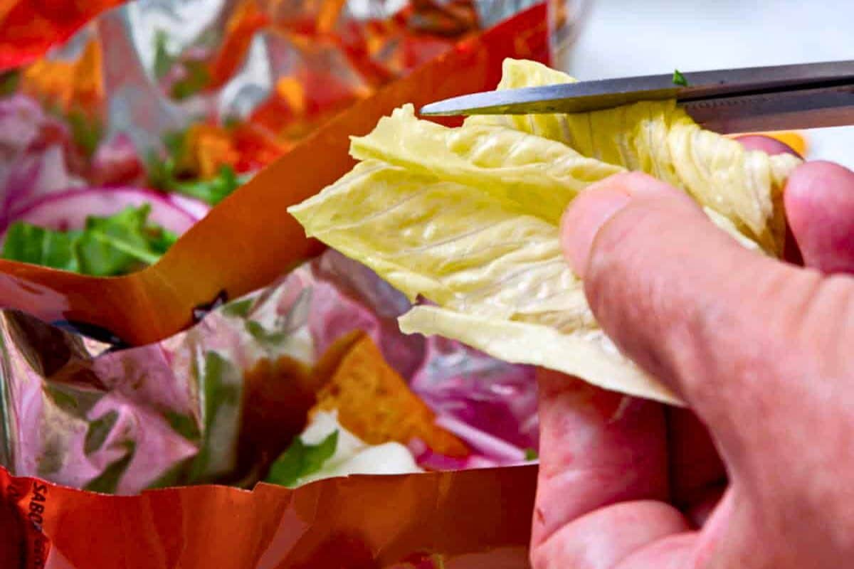 Cutting lettuce into taco in a bag/walking tacos.