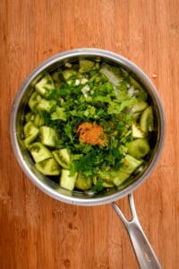 Tomatillo salsa ingredients in a pot of water.