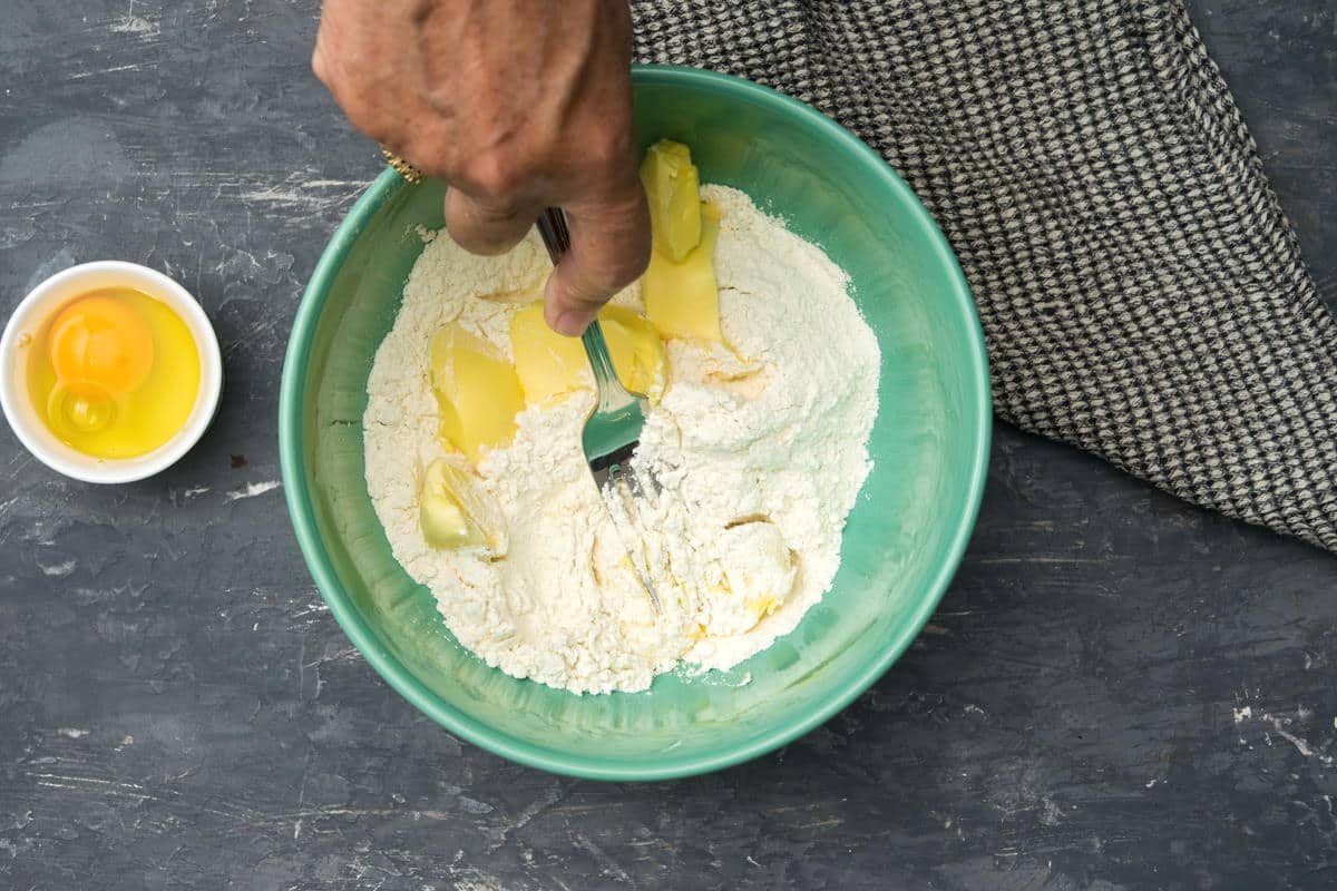 Flour and butter in a bowl with a fork.