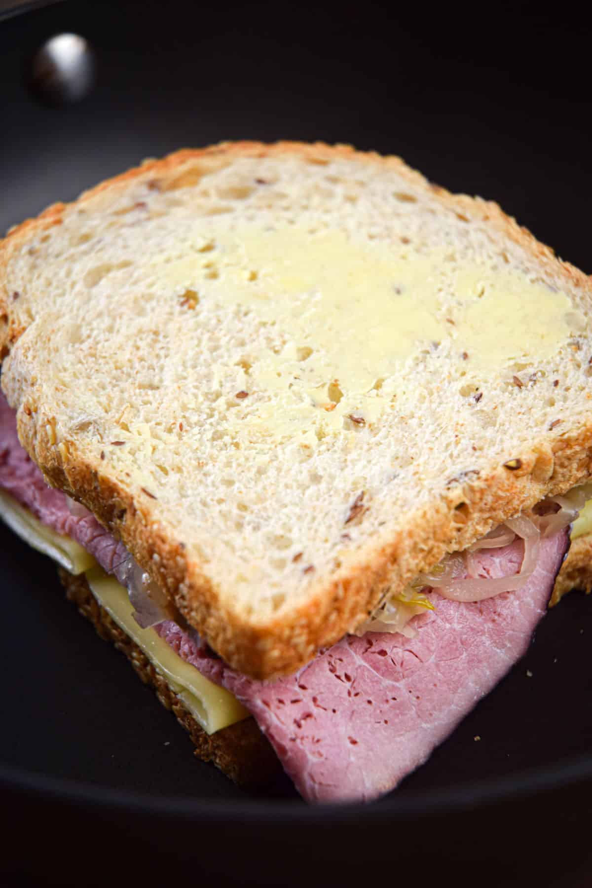 Reuben sandwich in frying pan.