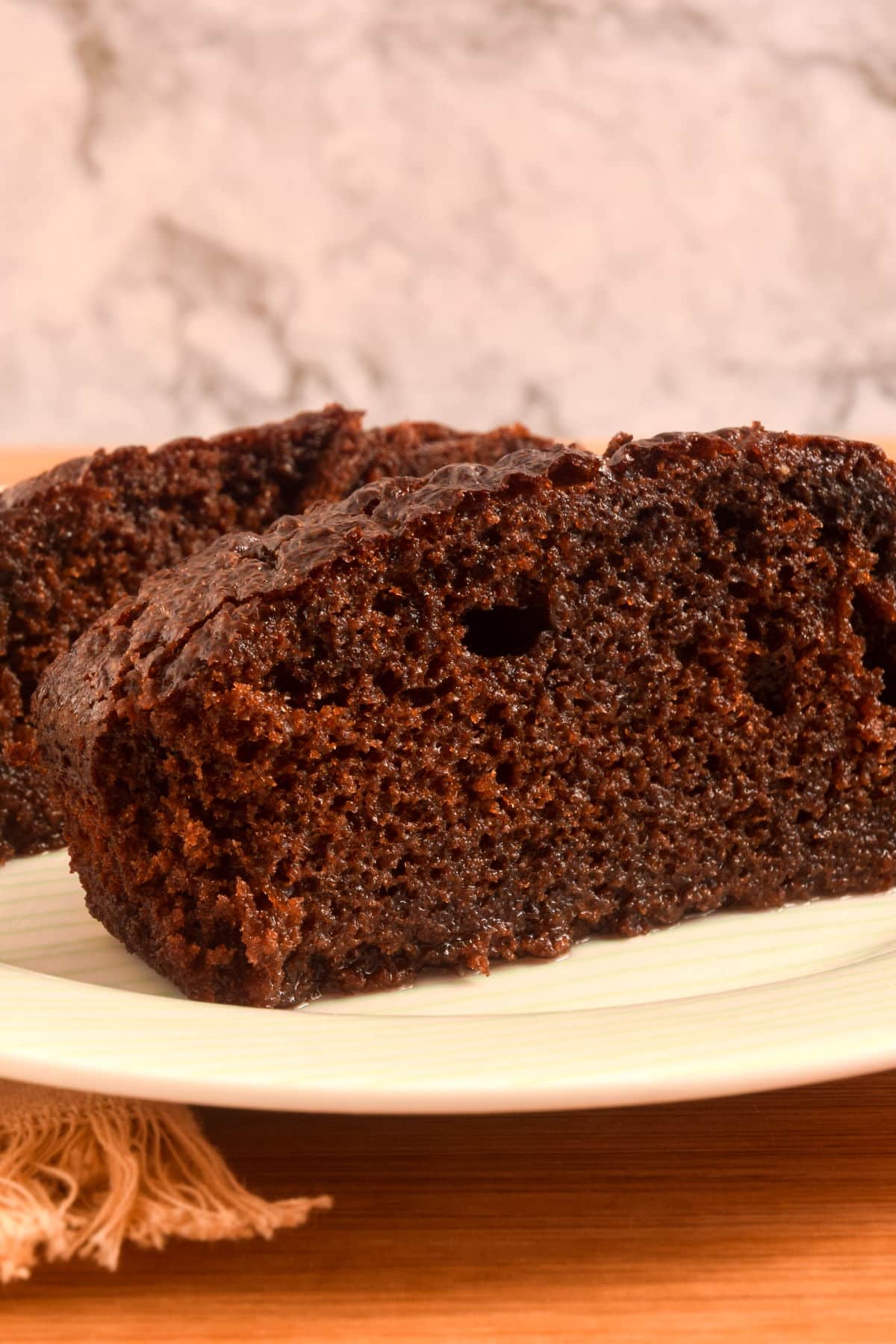 Pieces of moist chocolate cake on plate.