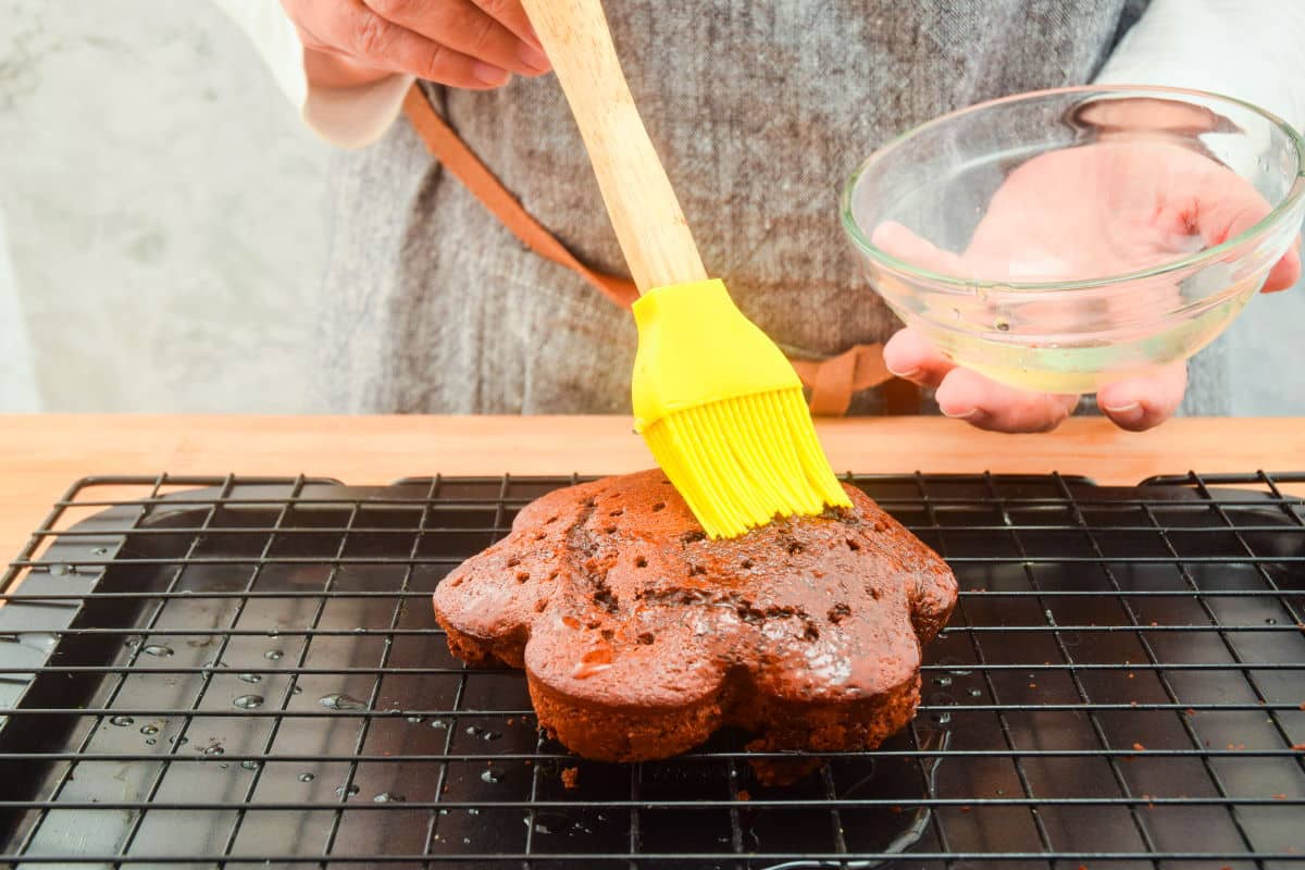 Chocolate cake and a pastry brush with simple syrup.