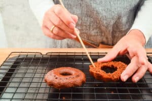 Small chocolate cake sliced in half with wooden skewer.