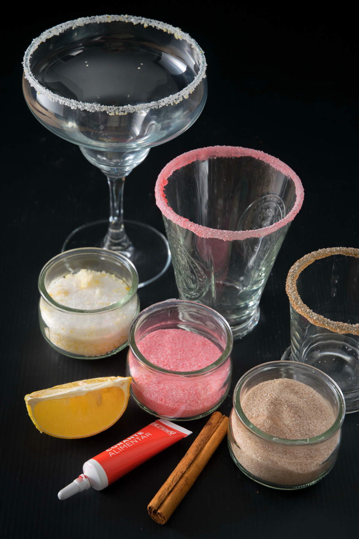 Assortment of glasses that have been rimmed with sugar.