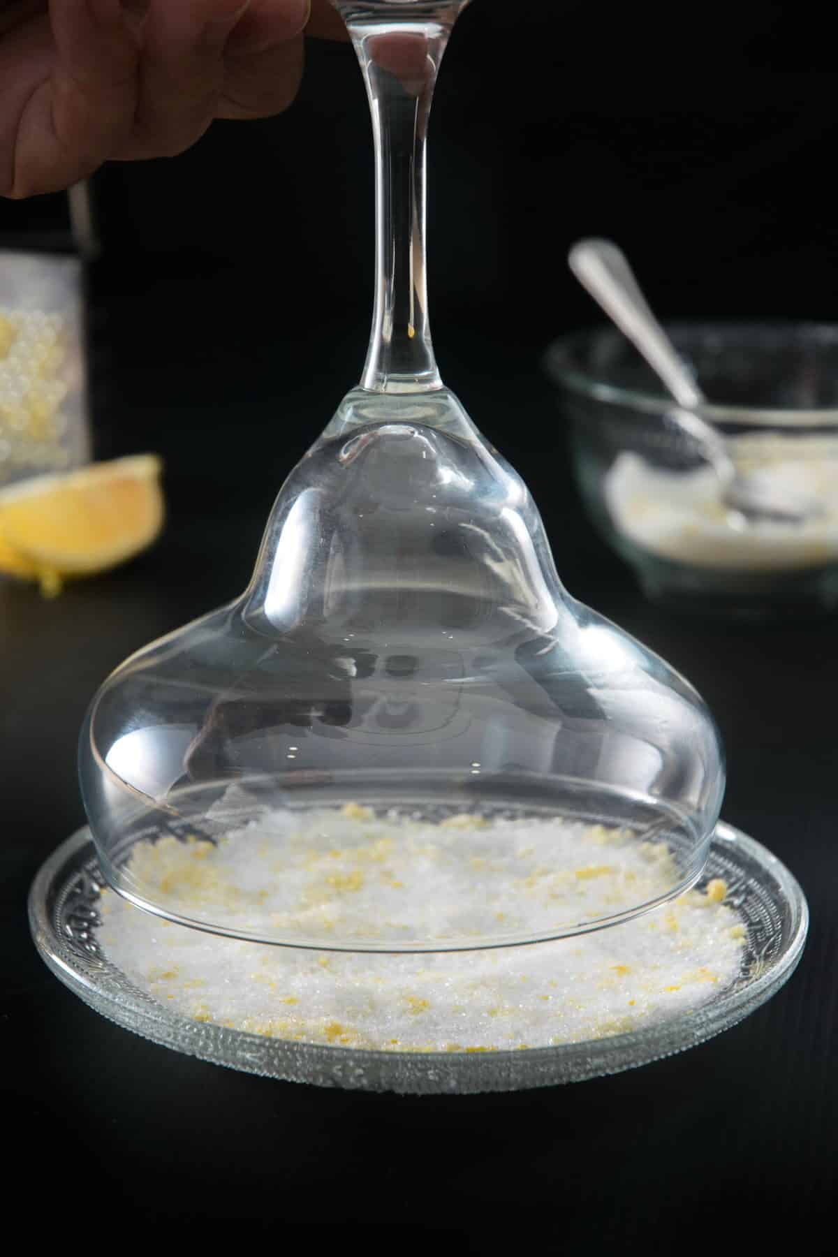 Margarita glass dipping into sugar rim.