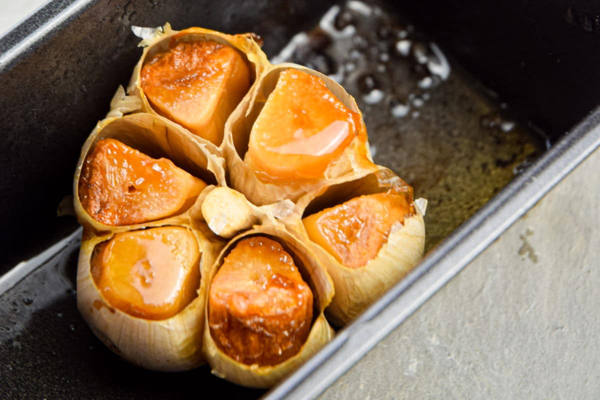 Roasted garlic head in pan.
