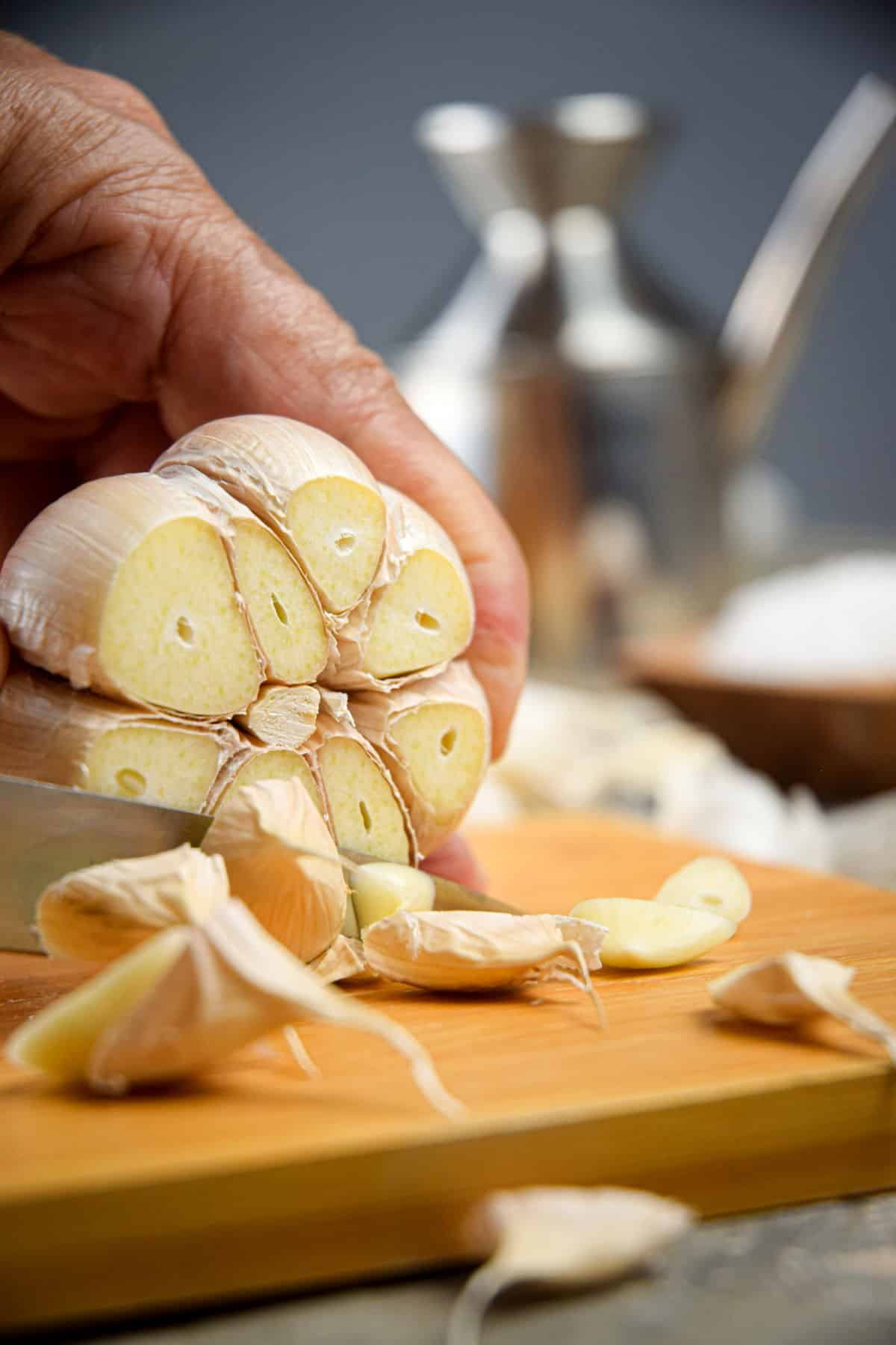 Raw garlic head on cutting board.