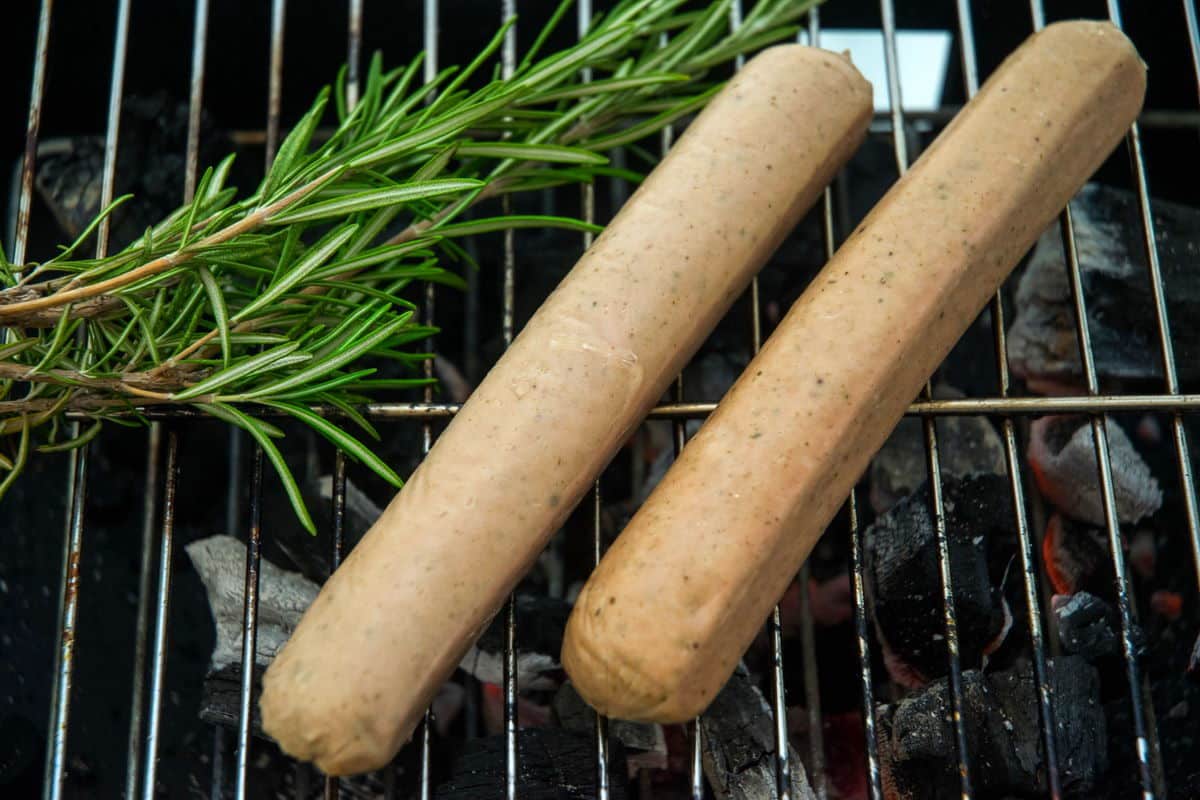 Bratwurst sausages on the grill with rosemary.