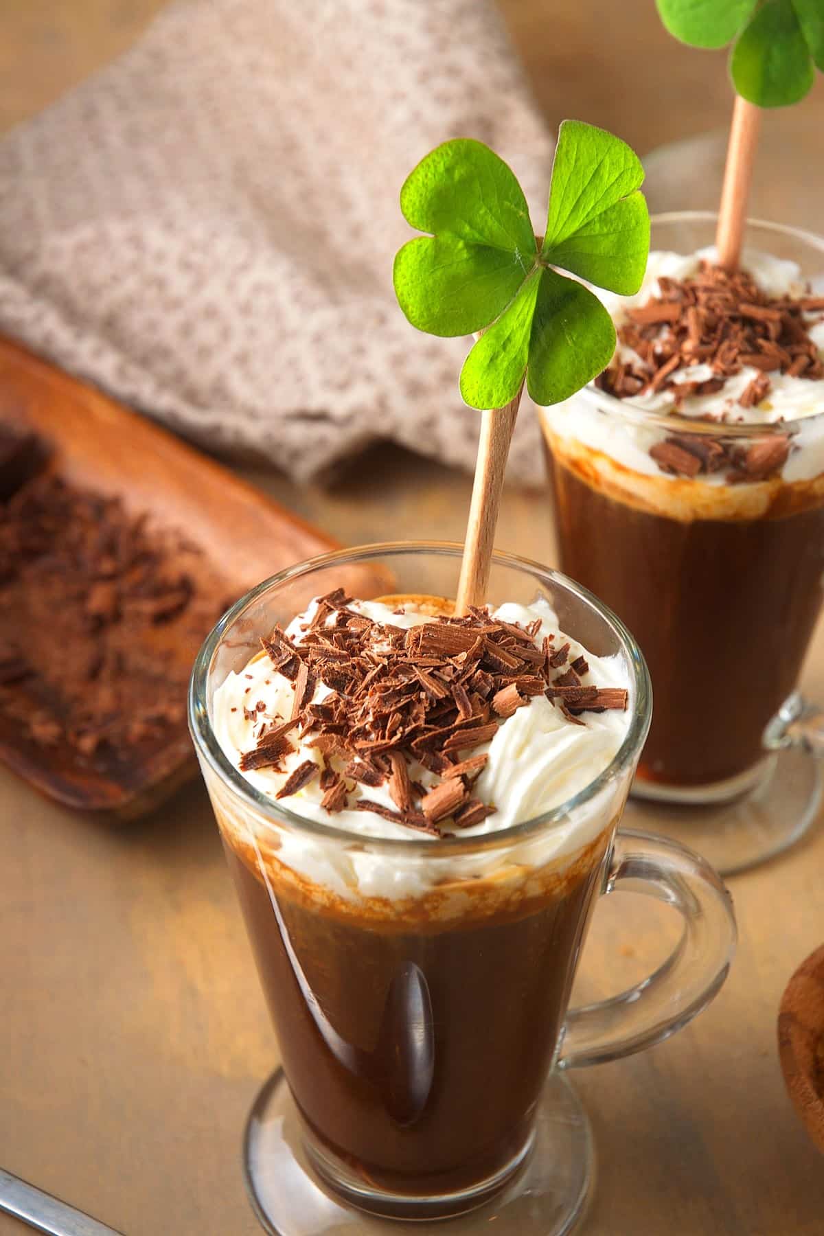 Irish coffee in coffee mug with 4 leaf clover.