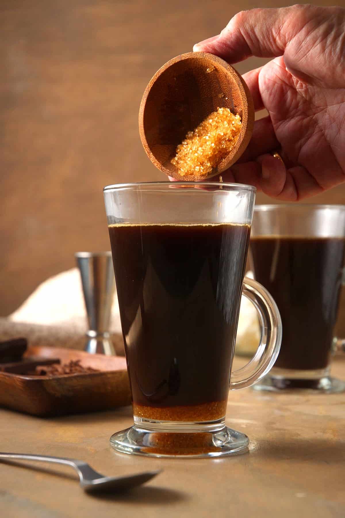 Irish coffee and brown sugar in Irish coffee glass.