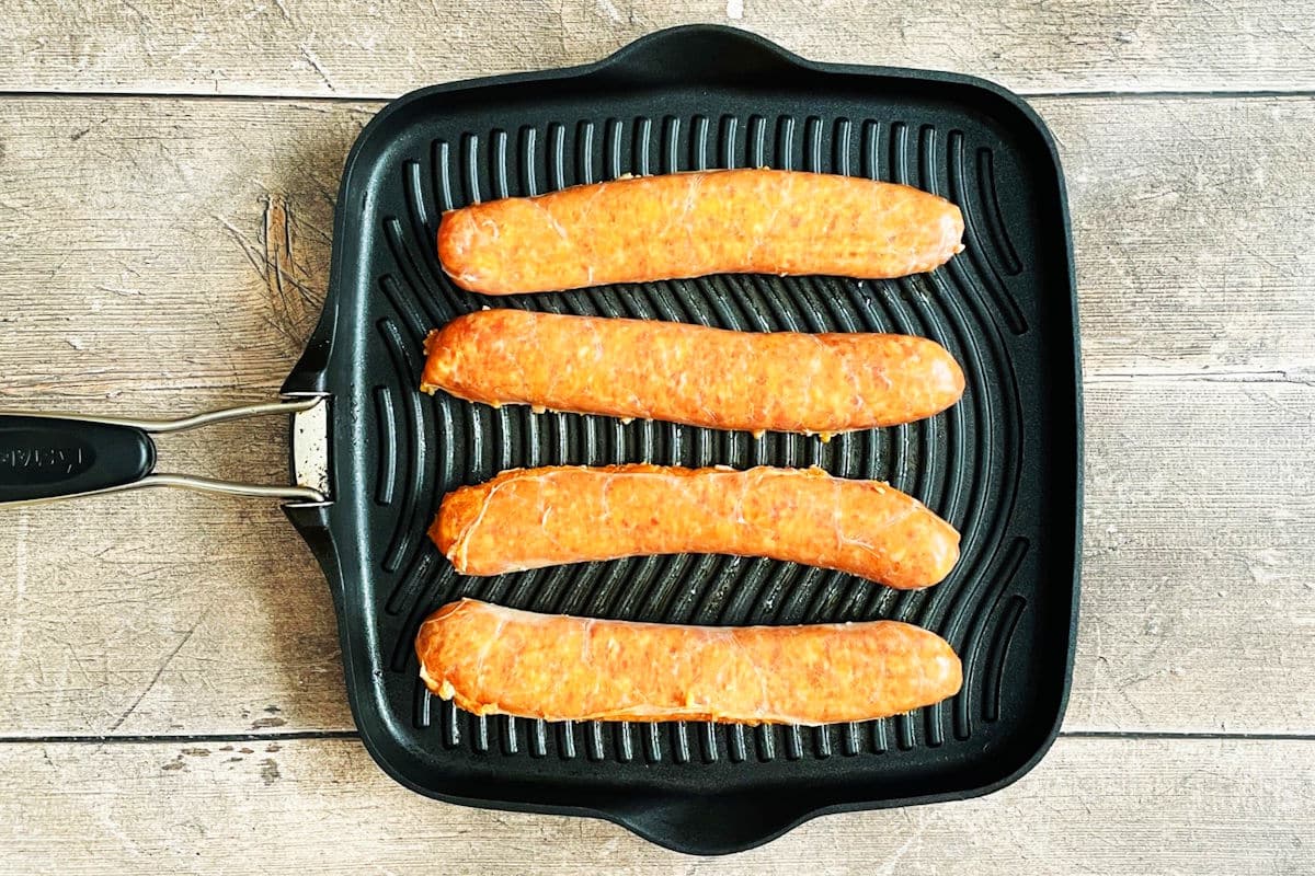 Italian sausages in cast iron grill pan.