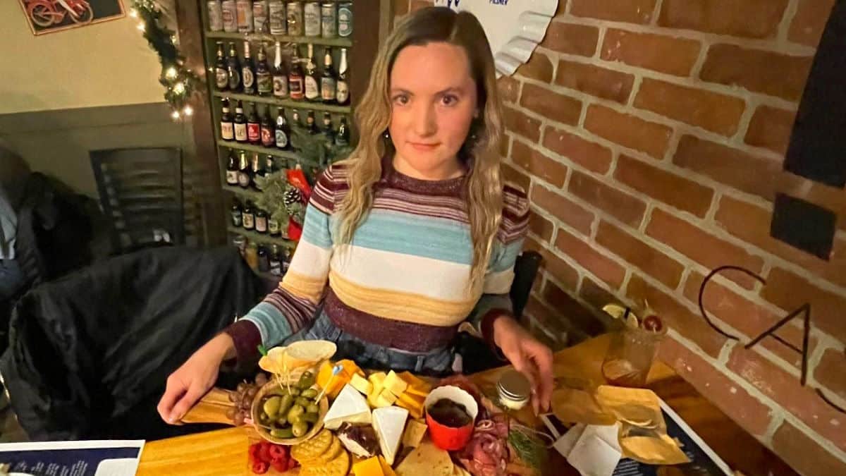 Joss holding a charcuterie board.