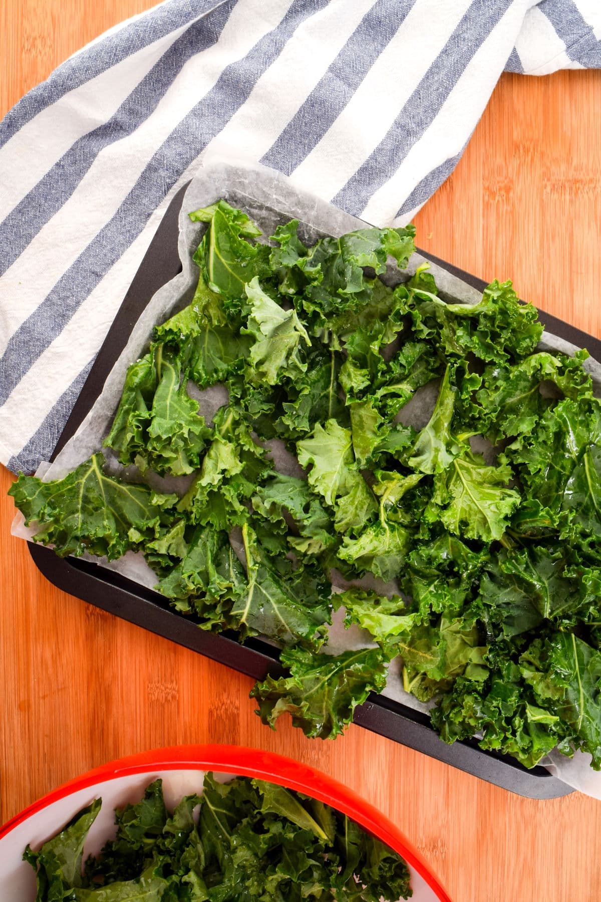 Kale pieces on parchment-lined sheet pan.