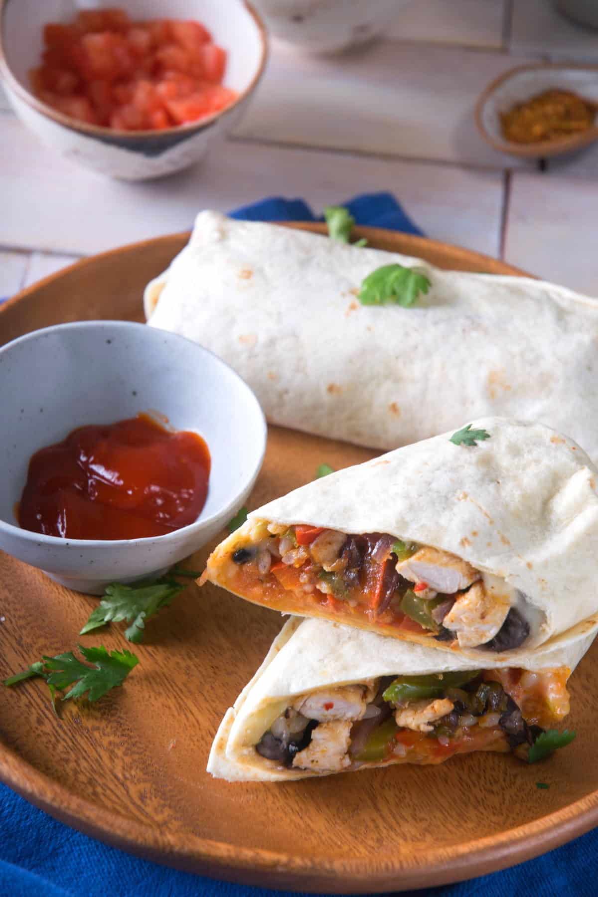 Kimchi burritos sliced and stacked on serving tray.