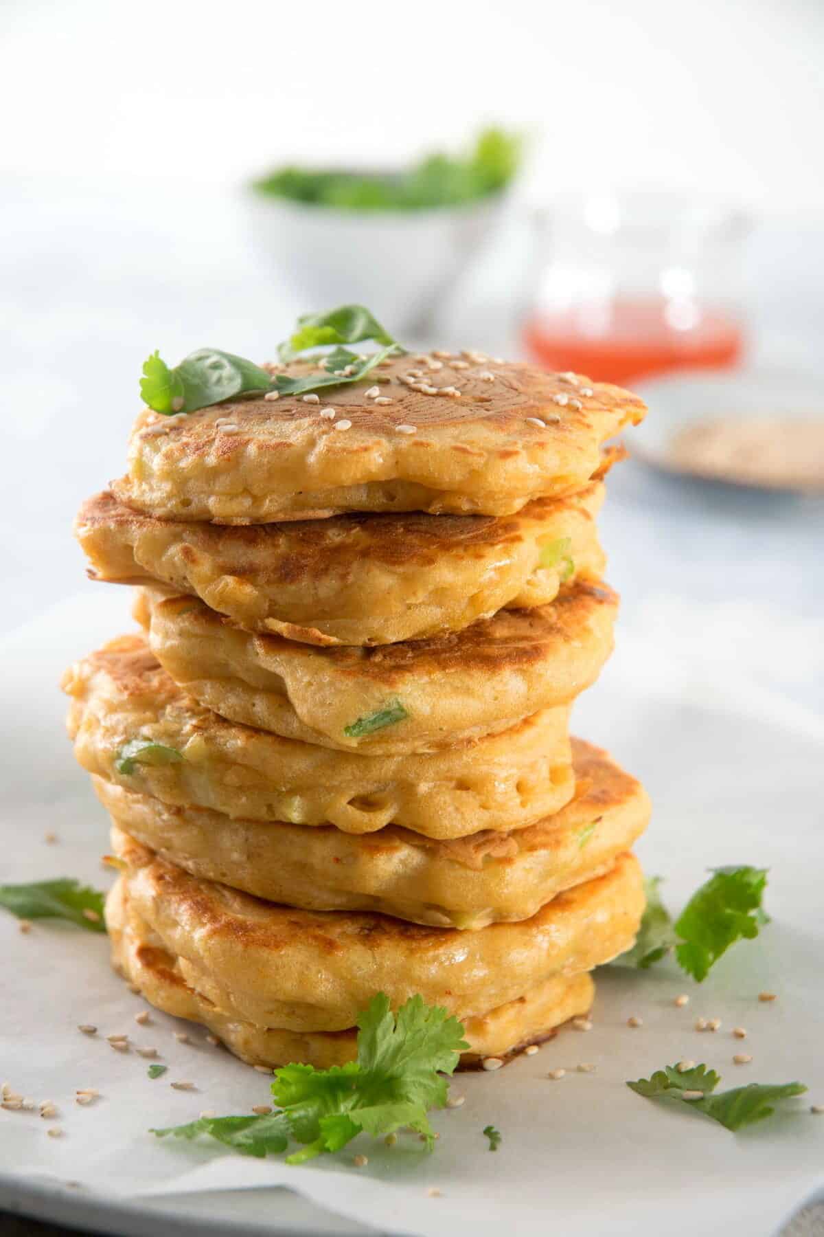 Kimchi pancakes stacked on a plate.