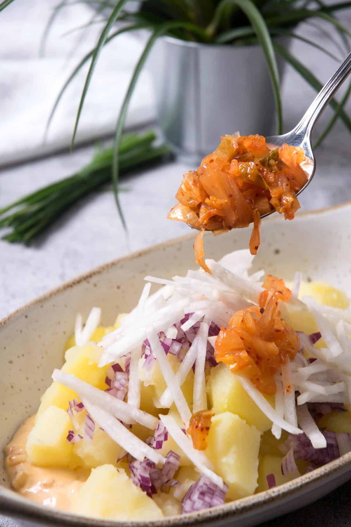 Kimchi potato salad ingredients in small casserole dish.