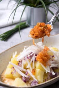 Kimchi potato salad ingredients in small casserole dish.