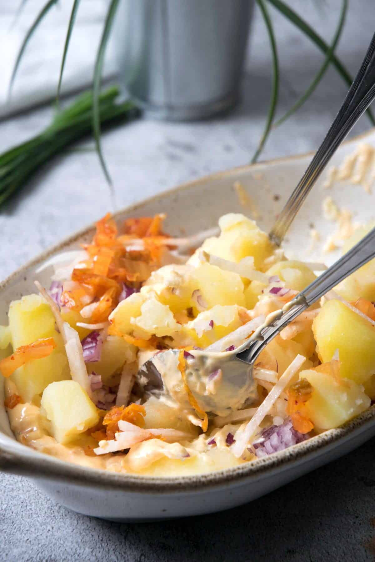 Kimchi potato salad mixed in casserole dish.