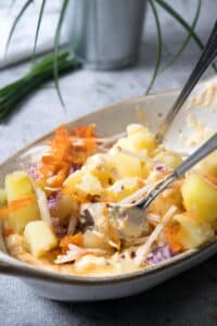 Kimchi potato salad mixed in casserole dish.