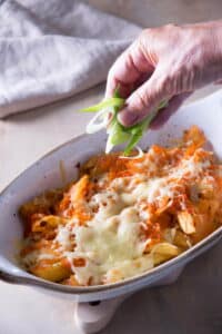 Baked fries with kimchi and cheese in a casserole dish.