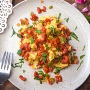 Chorizo and eggs on plate with fork.
