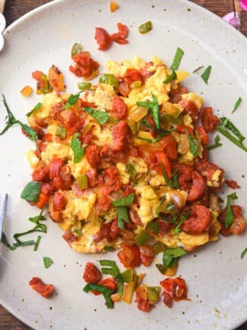 Chorizo and eggs on plate with fork.