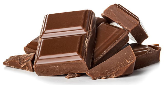 Milk chocolate pieces, white background.