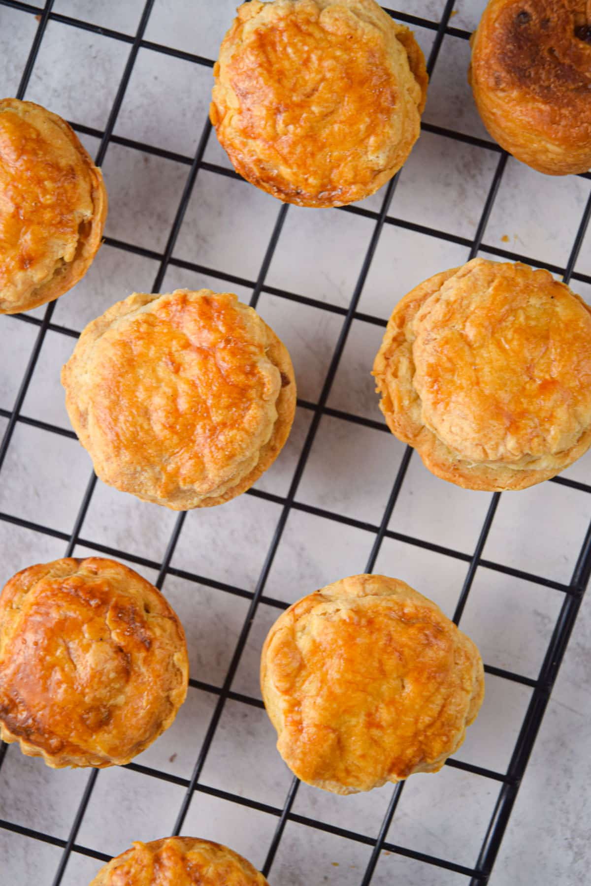 Mini apple pies on baking rack.