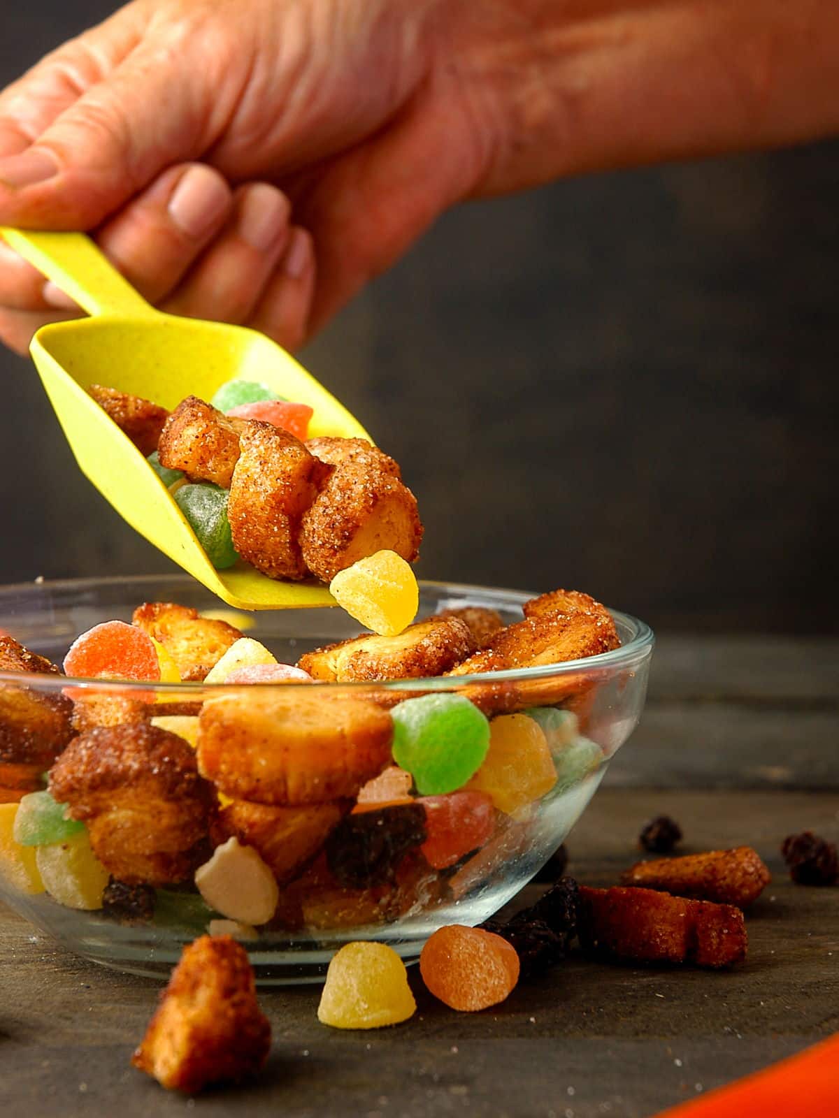 Churro snack mix in a bowl with a scoop.