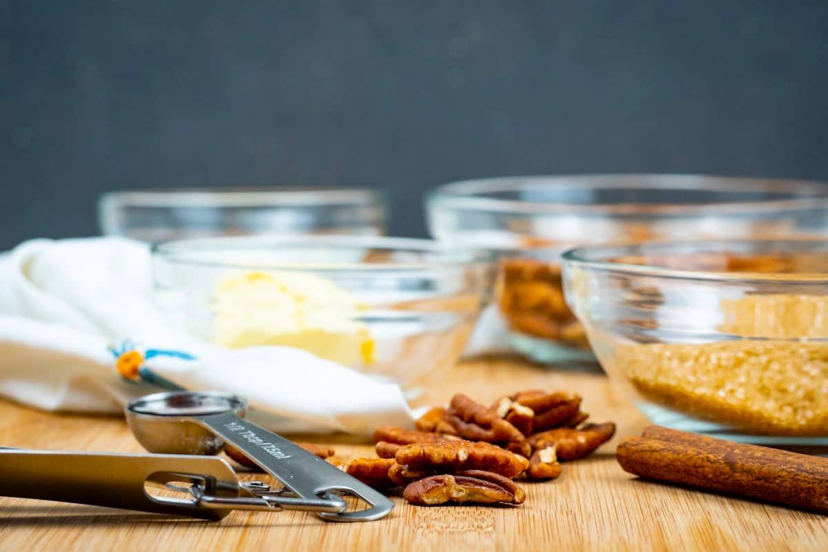 Praline ingredients prepped on wooden table.