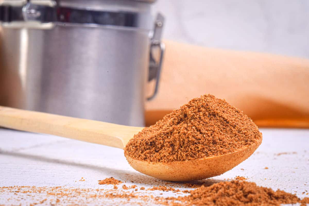 Pumpkin pie spice mix on wooden spoon.