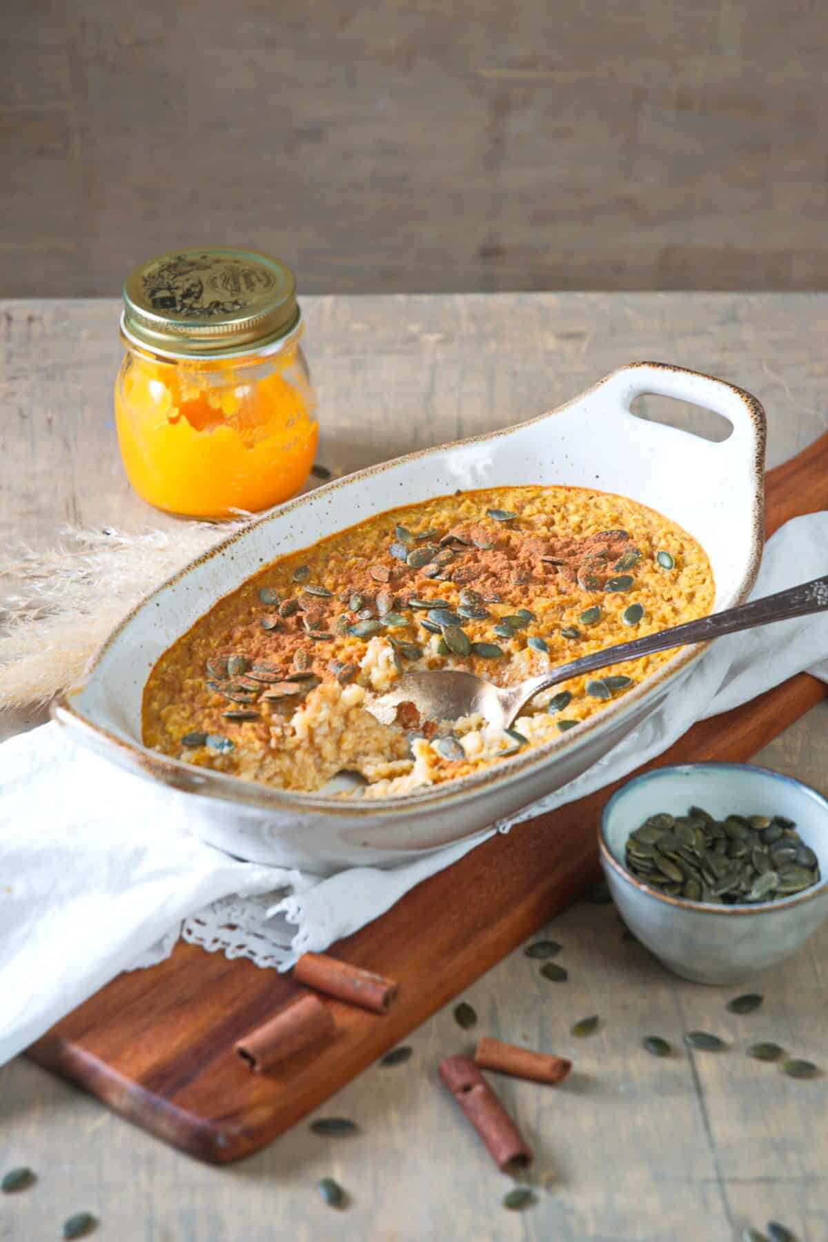 Pumpkin spice oatmeal in dish with spoon.