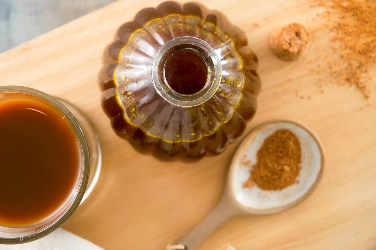 Pumpkin spice syrup in a small decorative jar.