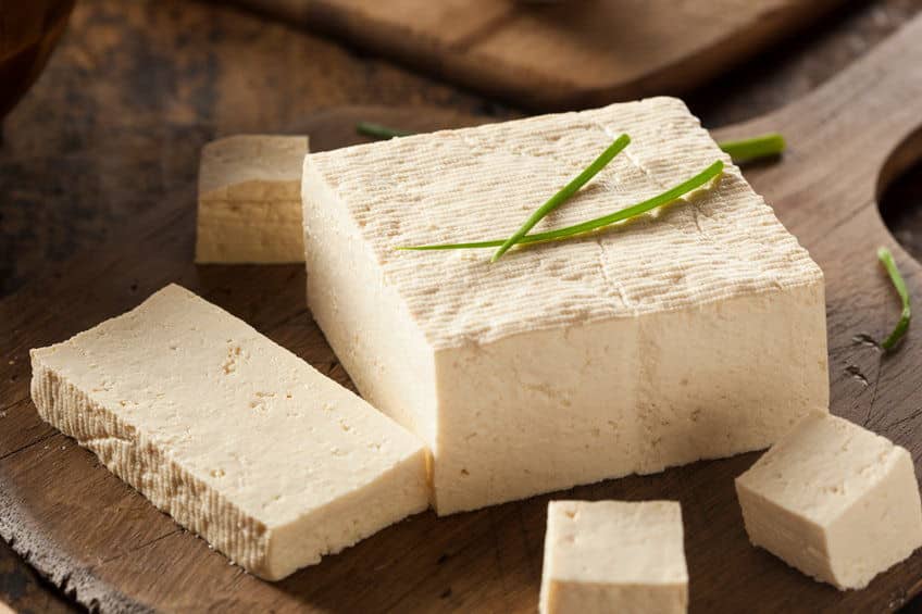 Organic Raw Soy Tofu on a Wooden Background.