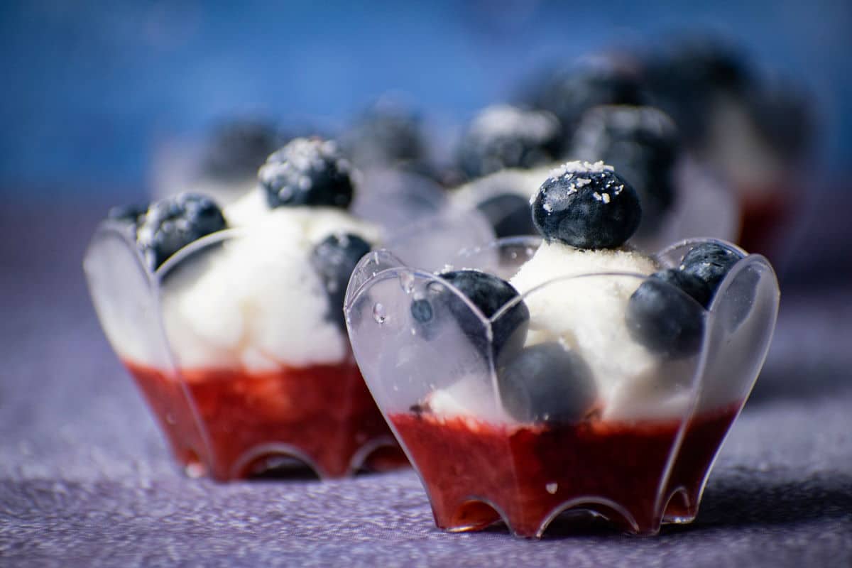 Fruit and ice cream dessert in dessert cup, close up.