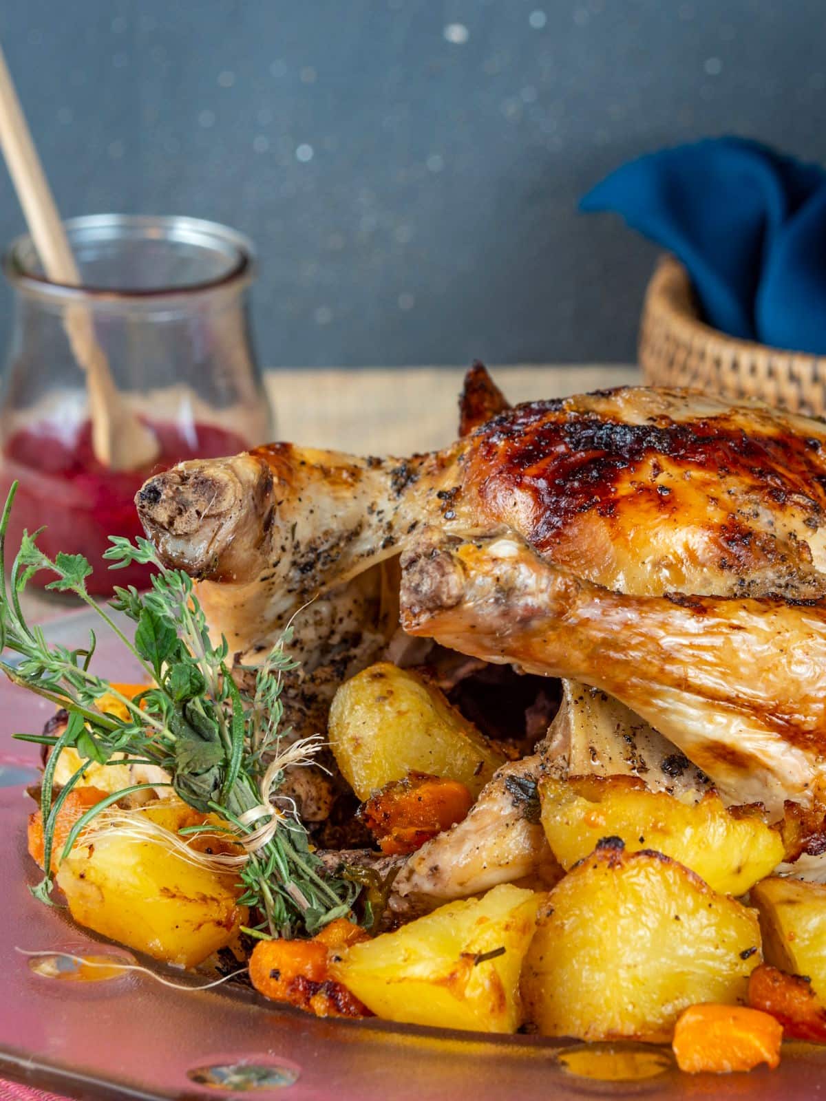 Roasted chicken stuffed with vegetables and herbs on plate.