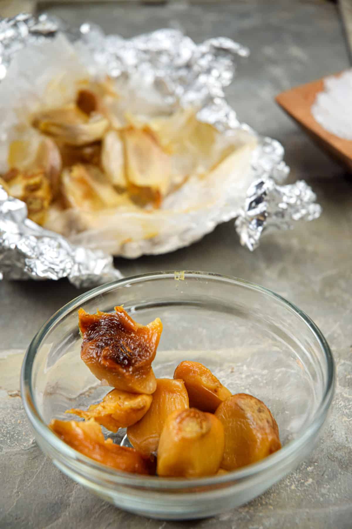 Roasted garlic cloves in small bowl.